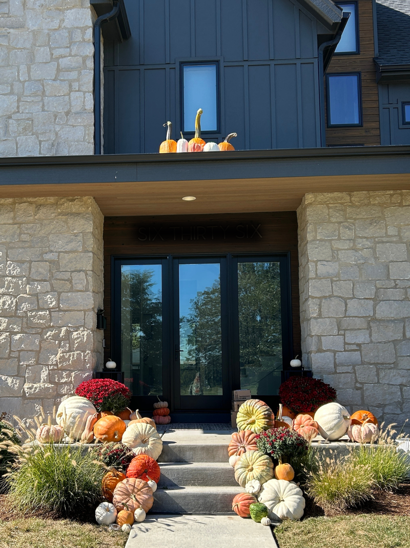 Decorative pumpkins on a stone house exterior